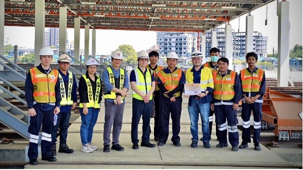 MRTA team photo standing in front of Buffer Stops on the Orange Line